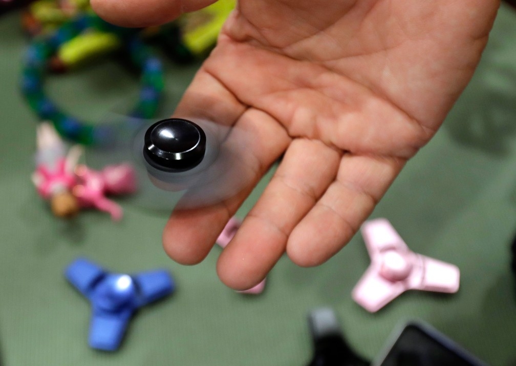 Pessoa utiliza um spinner em uma loja de brinquedos